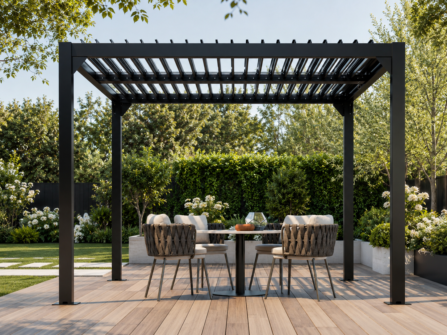 Patio with black pergola, outdoor furniture, and garden setting - Leading Landscapes Canterbury
