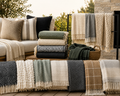 Collection of blankets and Cushions on a sofa and table outdoors - Leading Landscapes CAnterbury