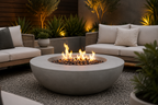 Outdoor setting with a fire pit table and seating area in a garden. Leading Landscapes Canterbury