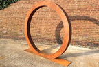 Corten steel ring art close-up showing weathered rust texture — Leading Landscapes Canterbury