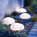 Orbit lighting - Glowing garden lights embedded in pebbles with plants — Leading Landscapes Canterbury