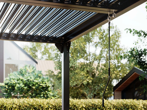 Patio cover with a retractable roof in a residential area - Leading Landscapes Canterbury