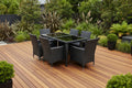 Black outdoor dining set with table and chairs on a new kwila deck - Leading Landscapes Limited