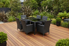 Black outdoor dining set with table and chairs on a new kwila deck - Leading Landscapes Limited