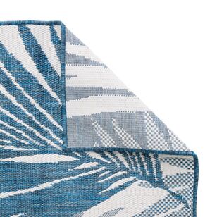 Blue and white patterned rug on a white background