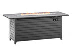 A rectangular outdoor fire pit table with a dark gray slatted body, featuring a glass wind guard and visible orange flames burning in the firebox on top, isolated on a white background. Leading Landscapes Canterbury