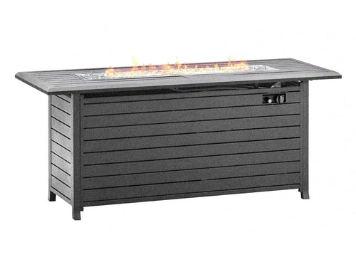 A rectangular outdoor fire pit table with a dark gray slatted body, featuring a glass wind guard and visible orange flames burning in the firebox on top, isolated on a white background. Leading Landscapes Canterbury