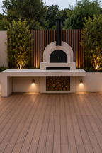 Outdoor pizza oven with wood storage in a garden setting - Leading Landscapes Limited