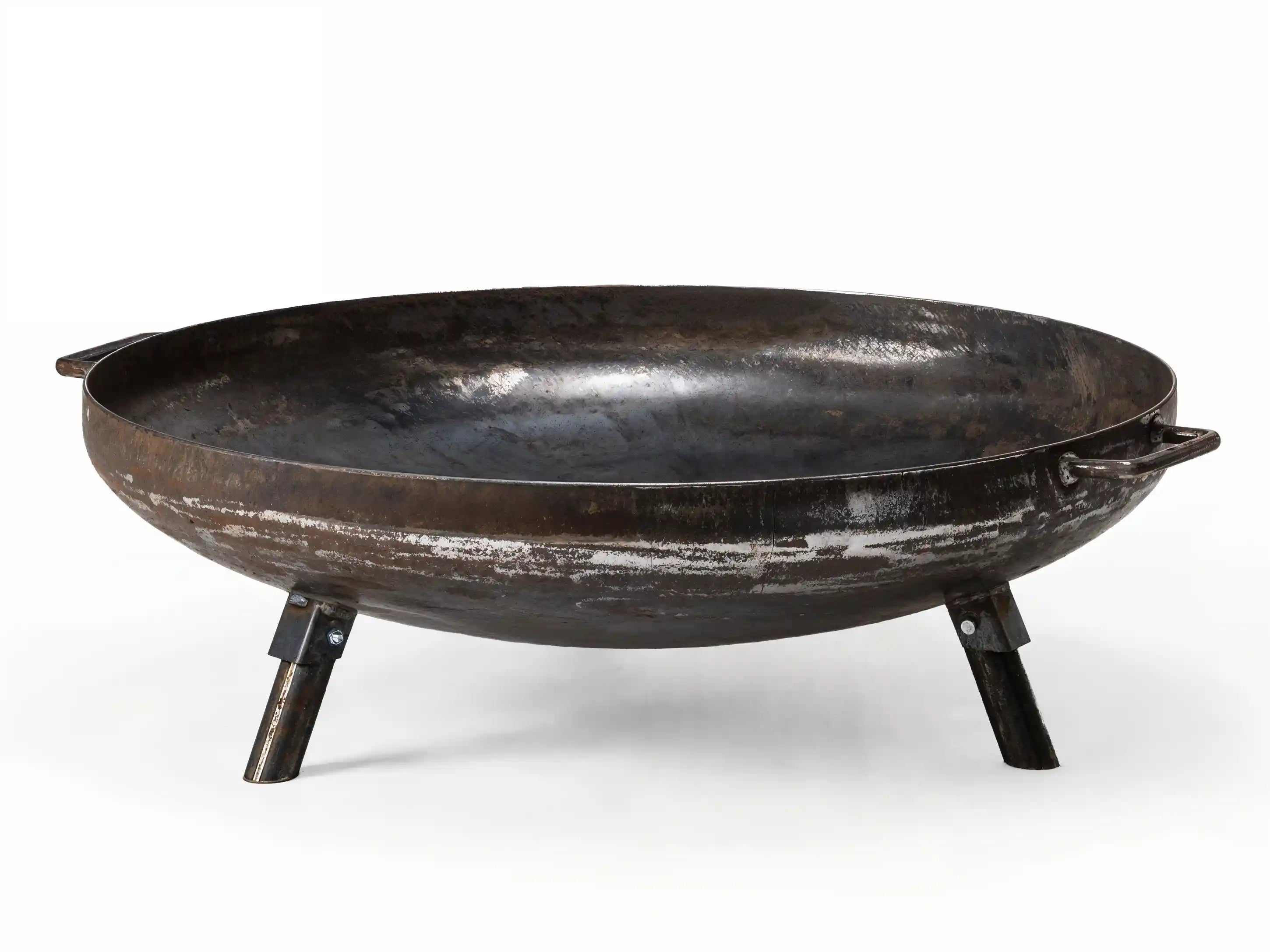 A round black cast iron fire pit with side handles and three legs, shown on a white background.